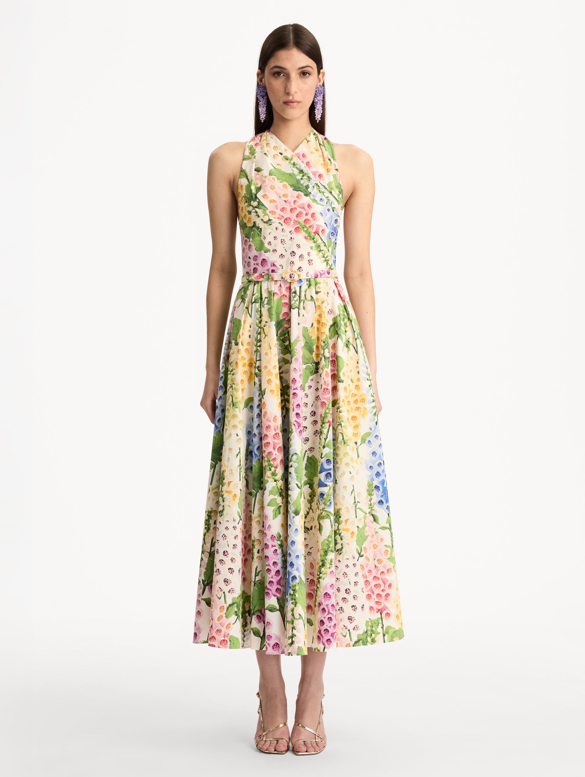 Foxglove Cotton Poplin Halter Dress with a fitted bodice and flowing skirt, featuring a colorful floral print in shades of pink, yellow, blue, and green. Front View.
