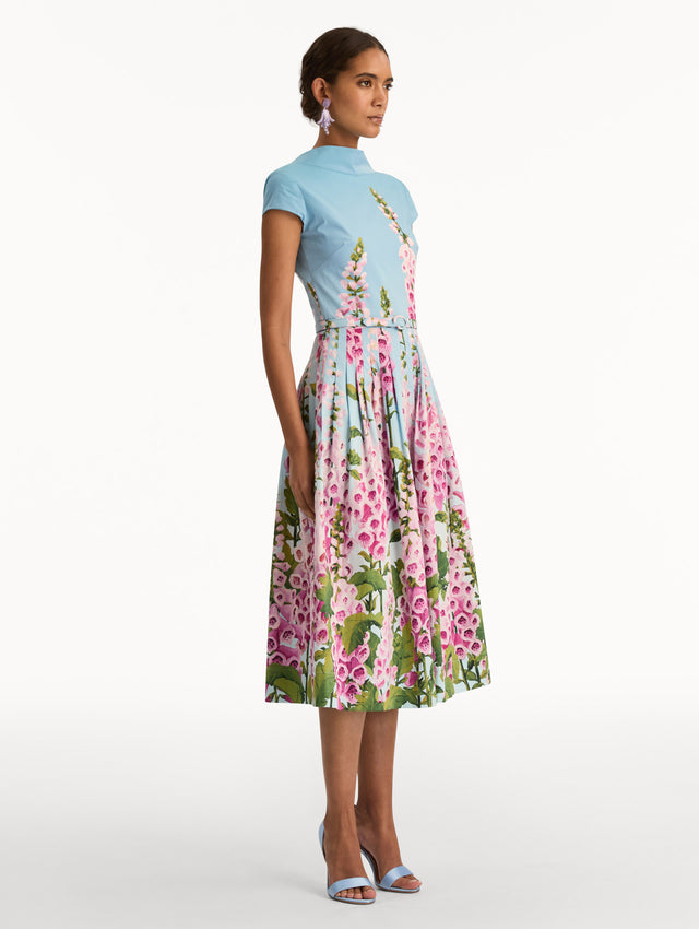Blue and pink Degradé Foxglove Cotton Poplin Dress with a belted waist, mock neckline, and tied open back. Side View.