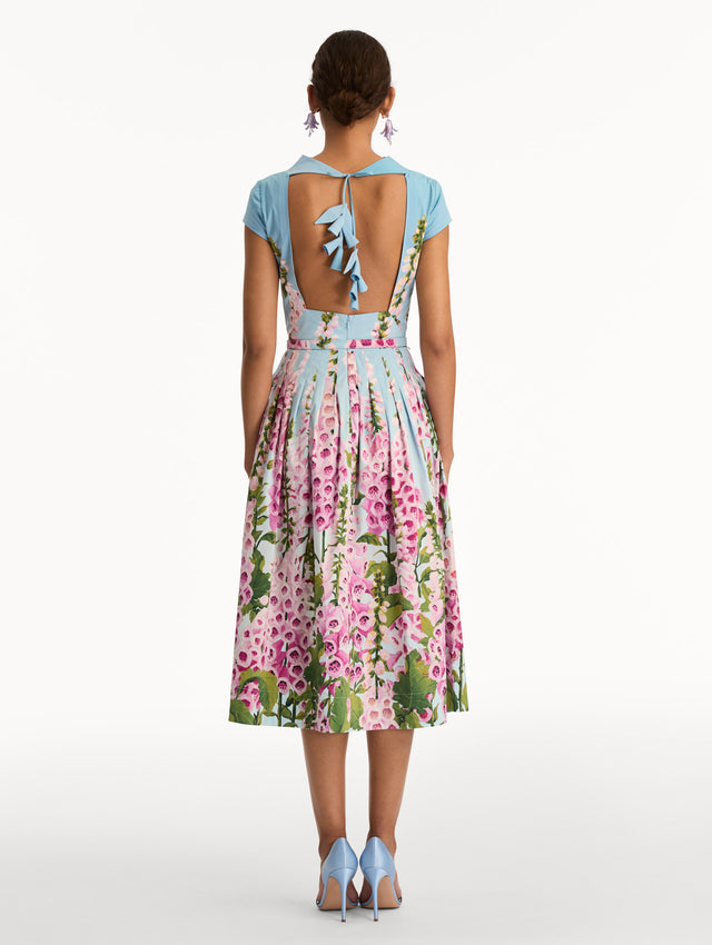 Blue and pink Degradé Foxglove Cotton Poplin Dress with a belted waist, mock neckline, and tied open back. Back View.