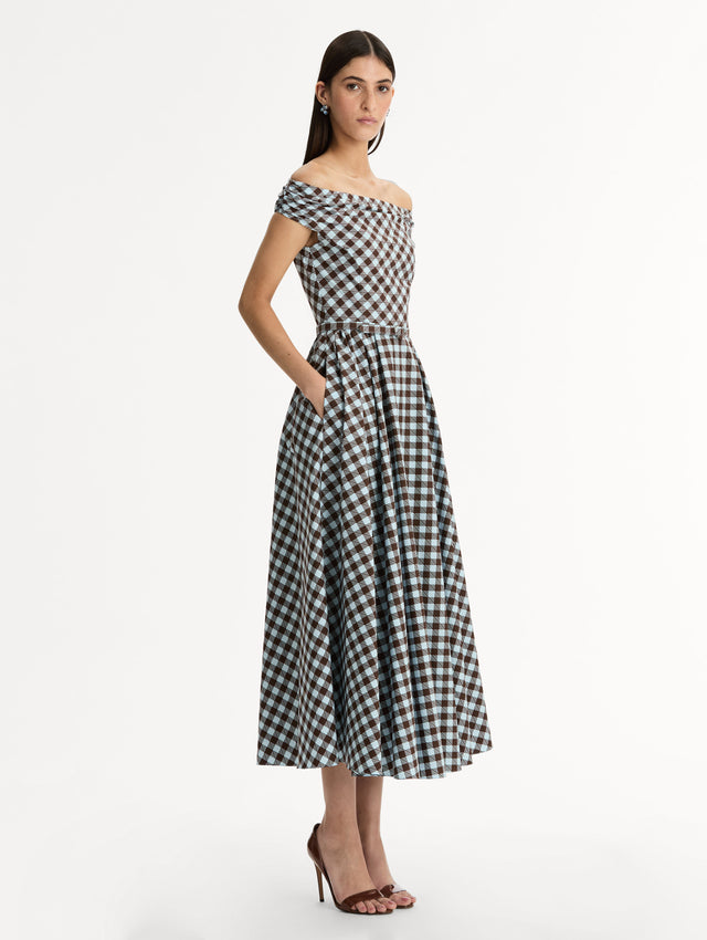 Gingham Cotton Poplin Midi Dress  in ice blue and mahogany. Off-shoulder neckline and pleated skirt. Side View. 