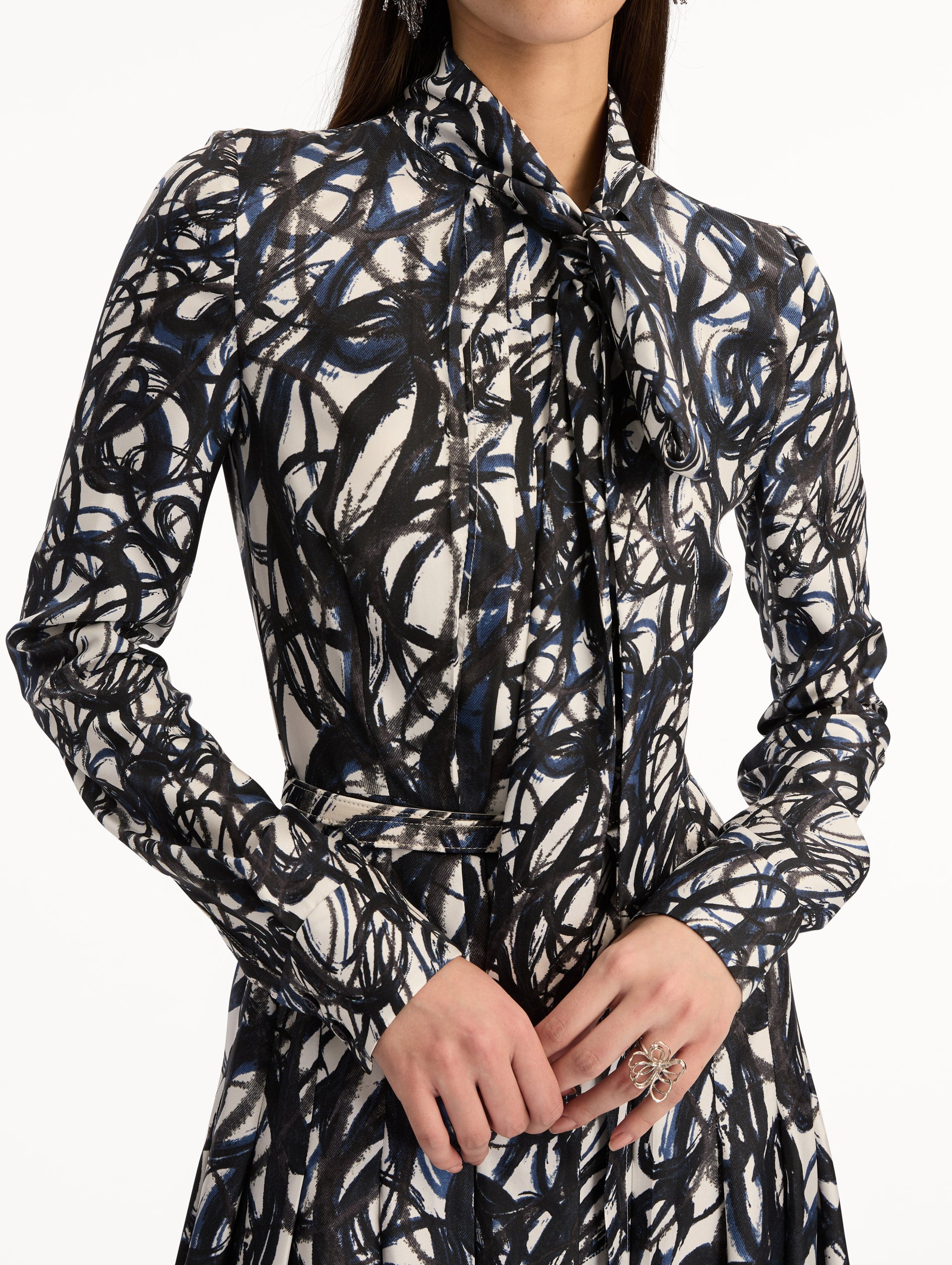 Ivory and Navy Abstract Sketch Silk Twill Dress with a belted waist and tie neck. Zoom View.