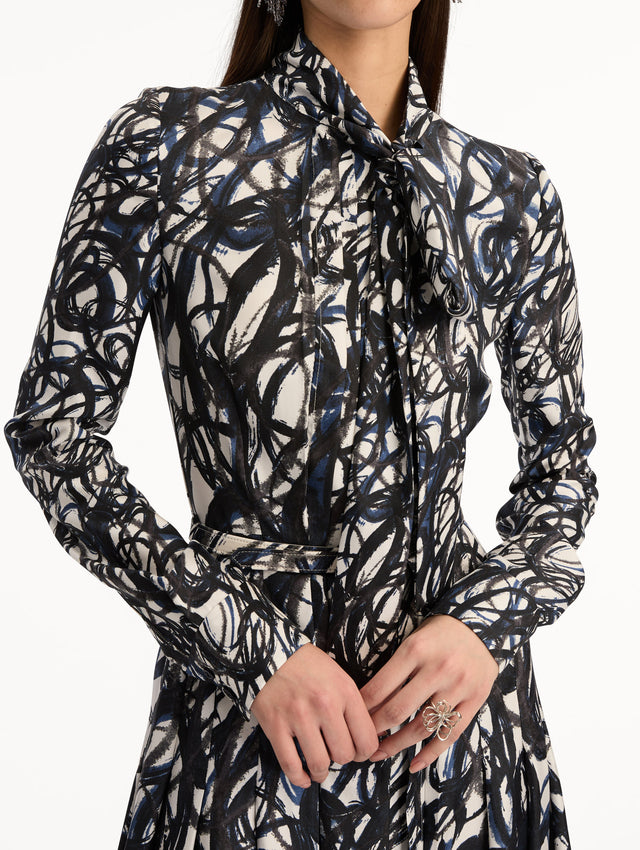 Ivory and Navy Abstract Sketch Silk Twill Dress with a belted waist and tie neck. Zoom View.