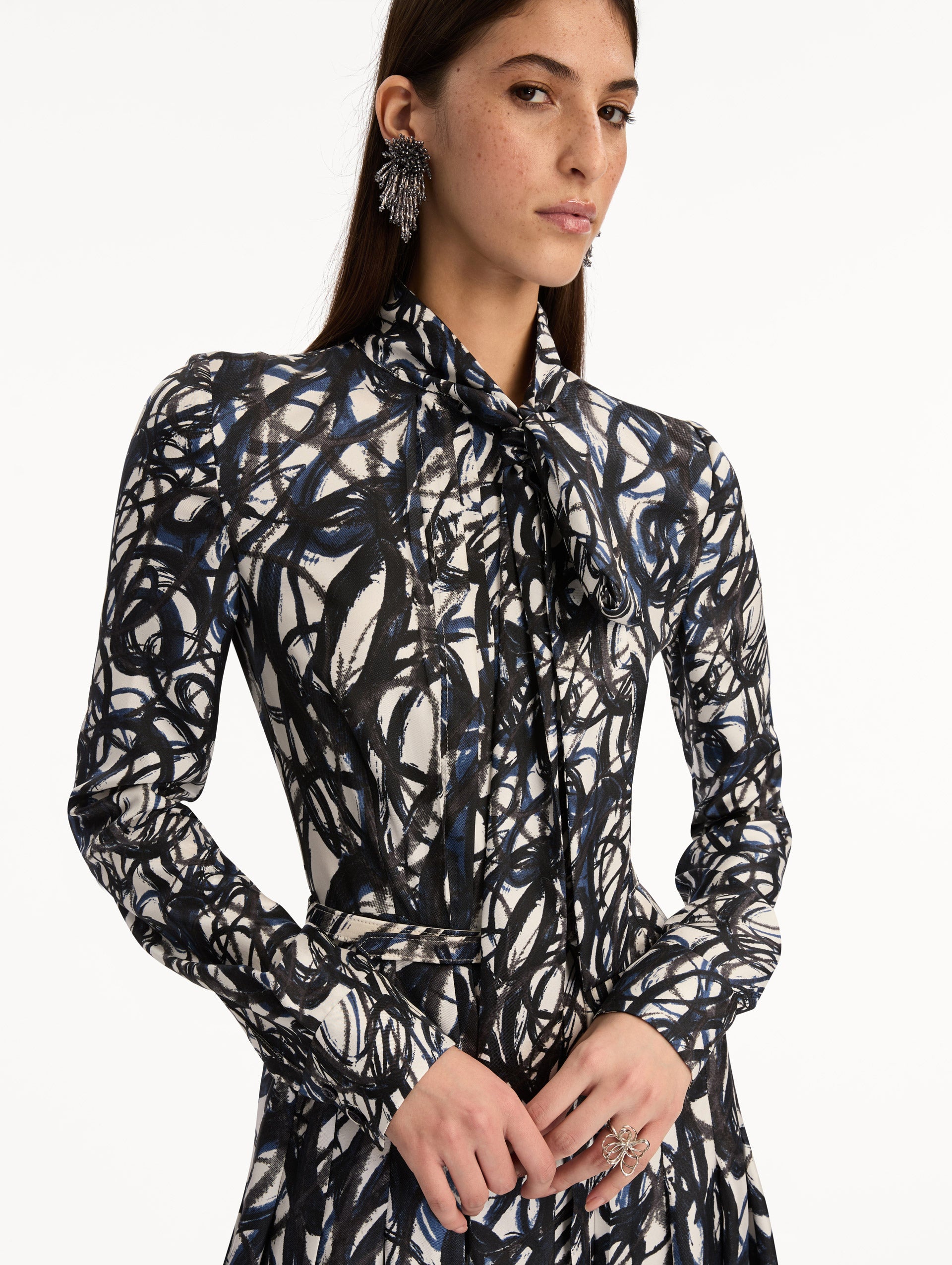 Ivory and Navy Abstract Sketch Silk Twill Dress with a belted waist and tie neck. Zoom View.