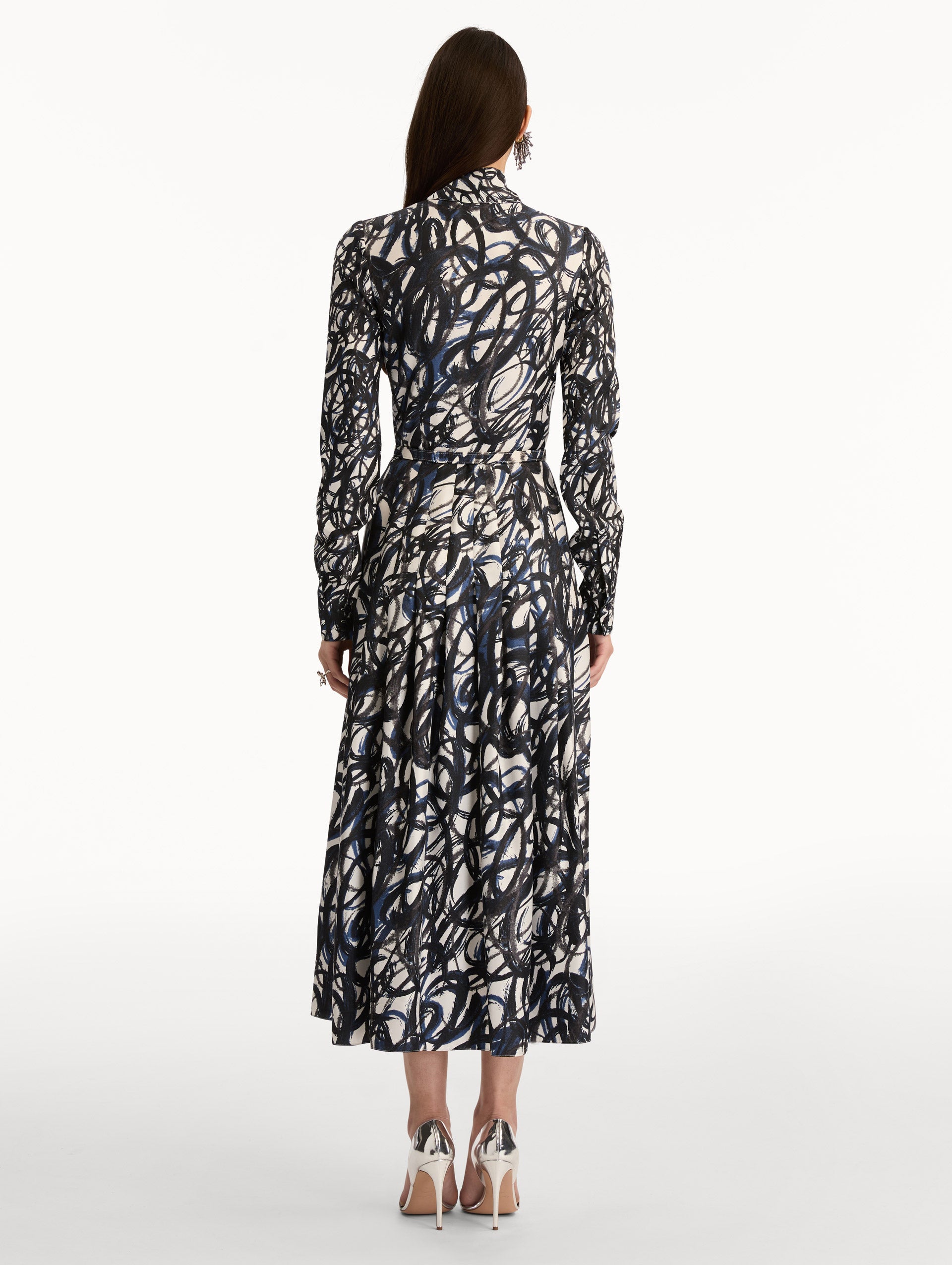 Ivory and Navy Abstract Sketch Silk Twill Dress with a belted waist and tie neck. Back View.