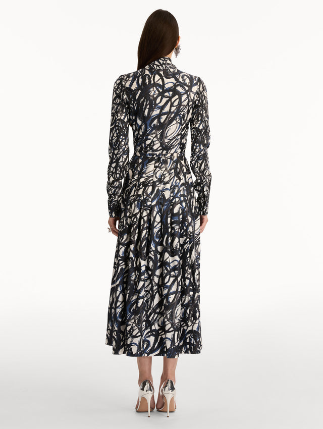 Ivory and Navy Abstract Sketch Silk Twill Dress with a belted waist and tie neck. Back View.