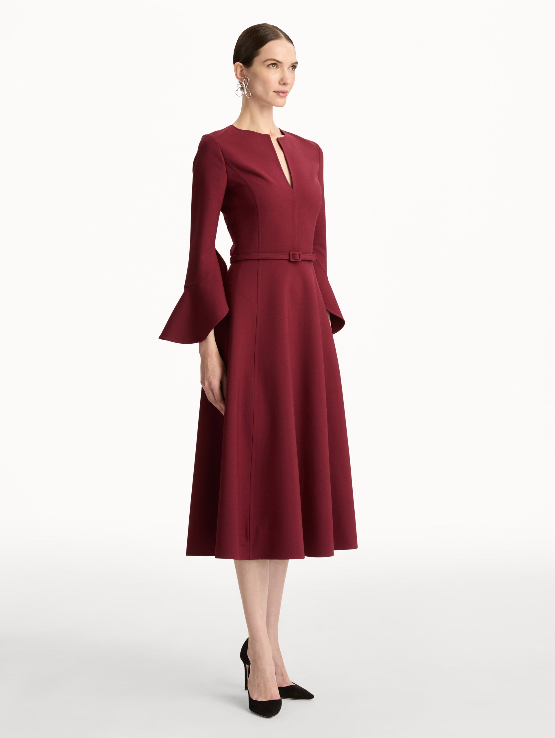 Wine colored Split Neck Wool Dress with belted waist and flowing bell sleeves. Side View.