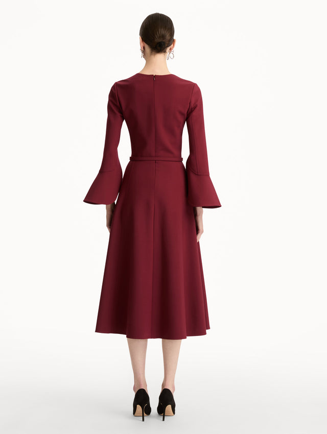 Wine colored Split Neck Wool Dress with belted waist and flowing bell sleeves. Back View.