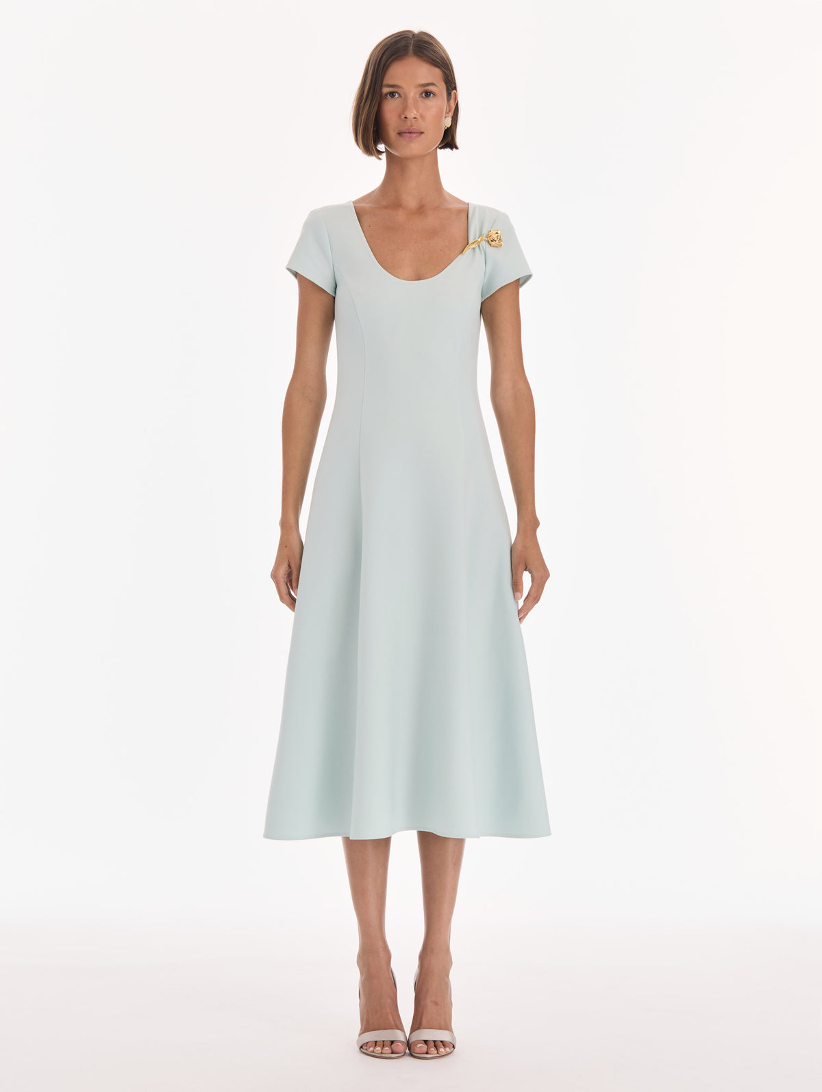 The model is wearing a short sleeve scoop neck stretch wool day dress. Front view.