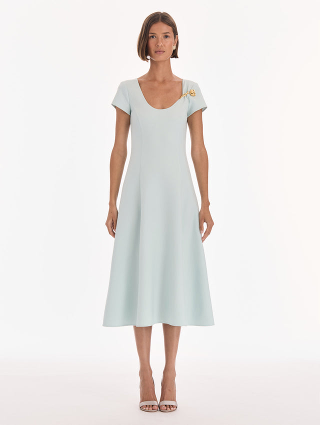 The model is wearing a short sleeve scoop neck stretch wool day dress. Front view.