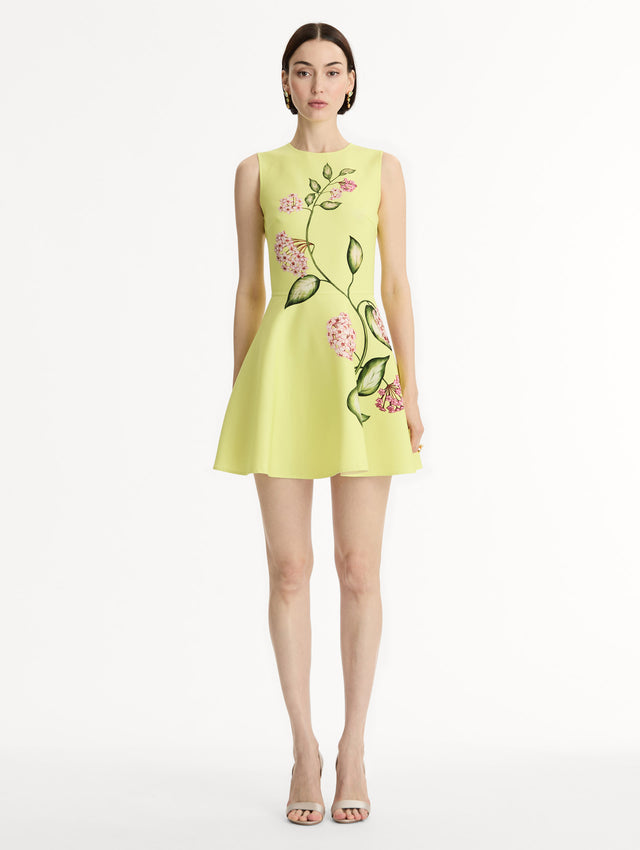 Halter Neck, Sleeveless Mini Dress in yellow sculpted wool with vidid pinkflower print. Front View.