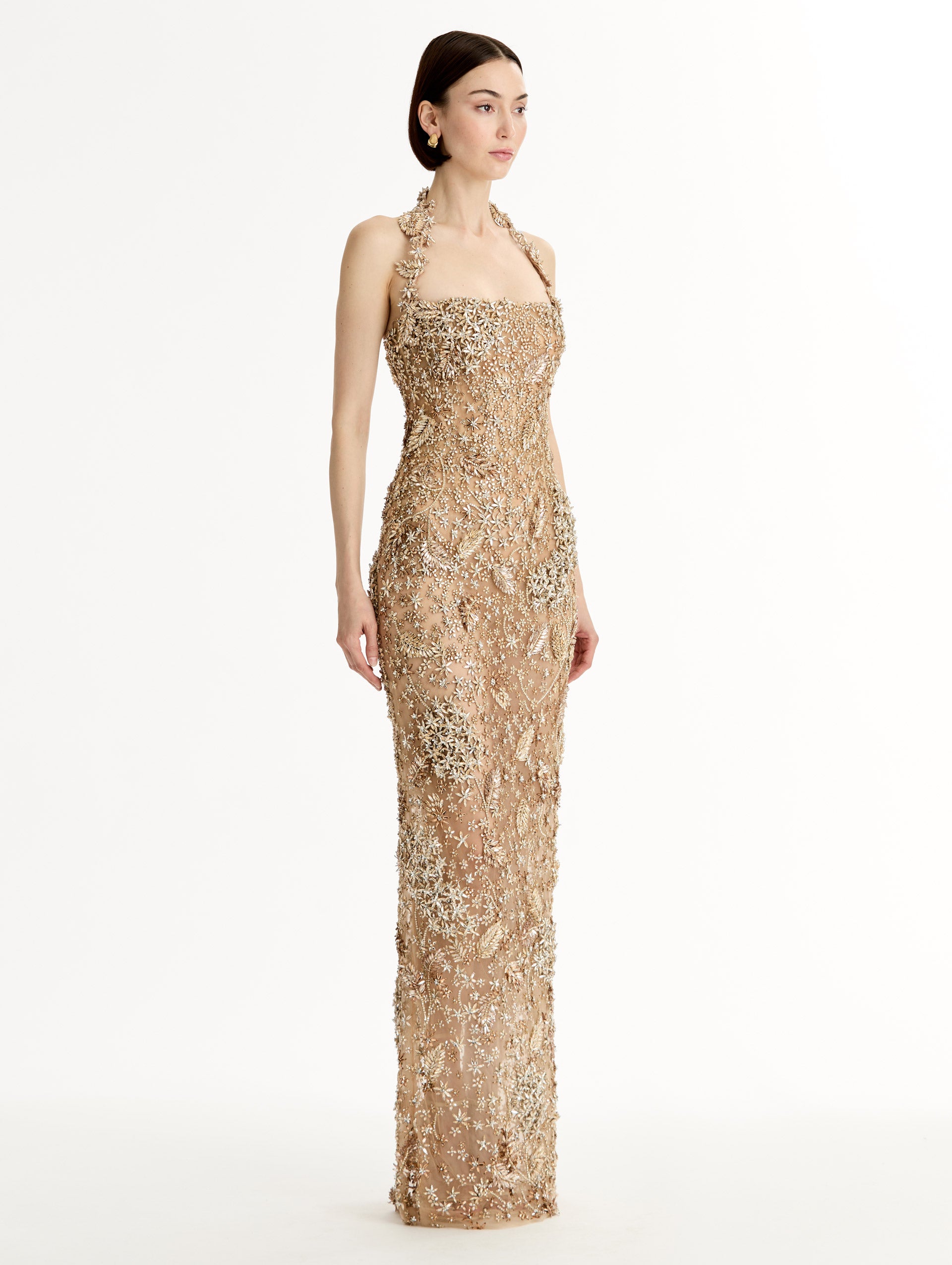 Floor length halter gown with intricate porcelain flower crystal embroidery. Sheer silhouette. SideView. 