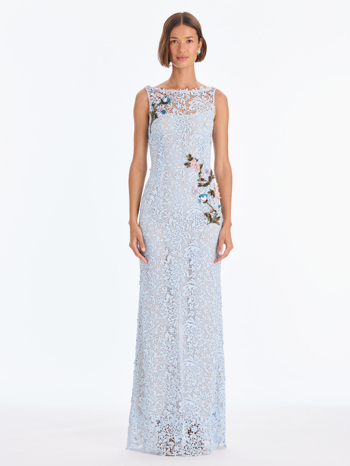 The model is wearing a sleeveless chrysanthemum guipure embroidered gown. Front view.