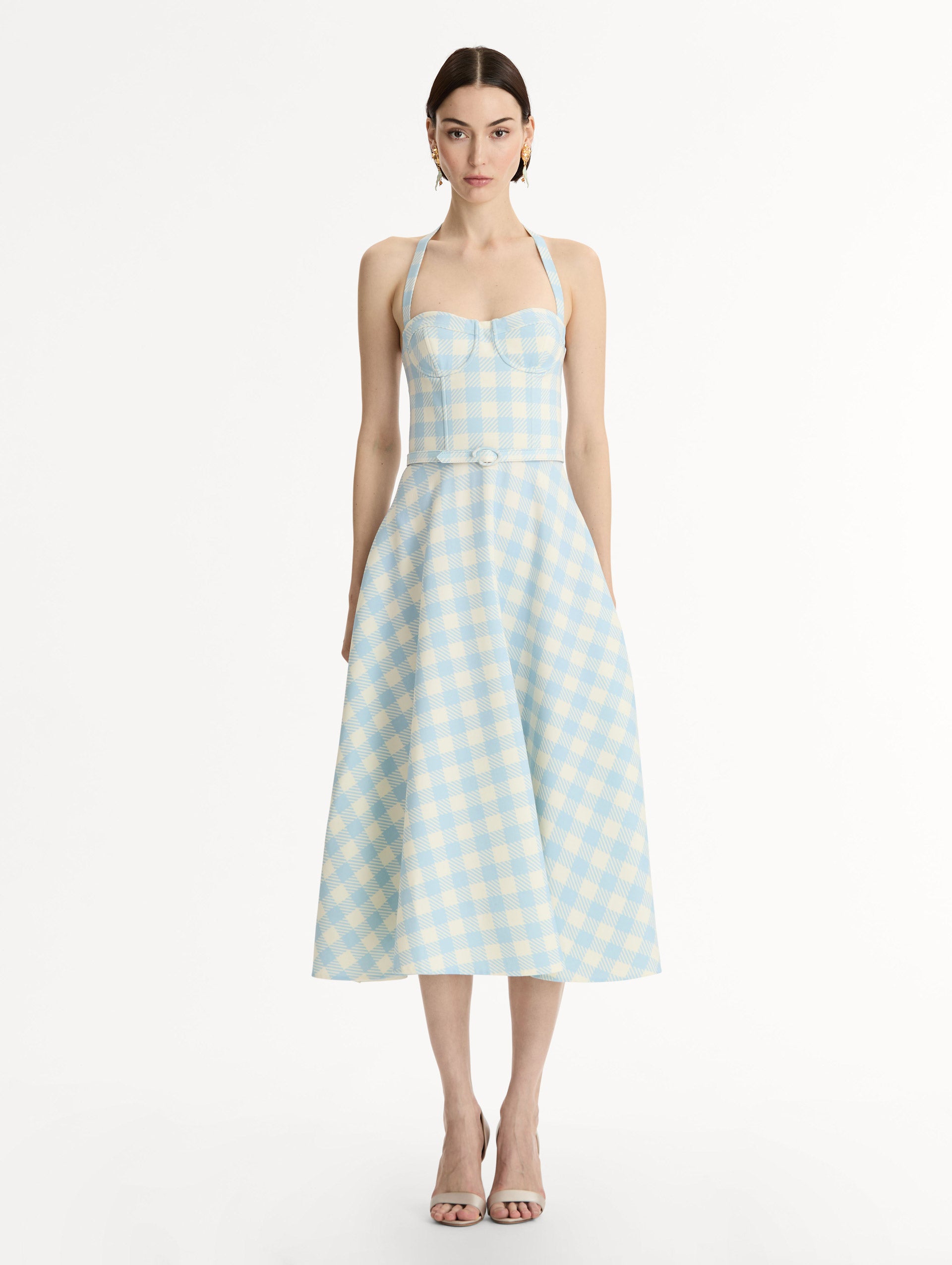 Pale blue and ivory gingham wool-blend halter dress. Structured bodice, flared midi skirt, and covered belt at the waist. Front View.