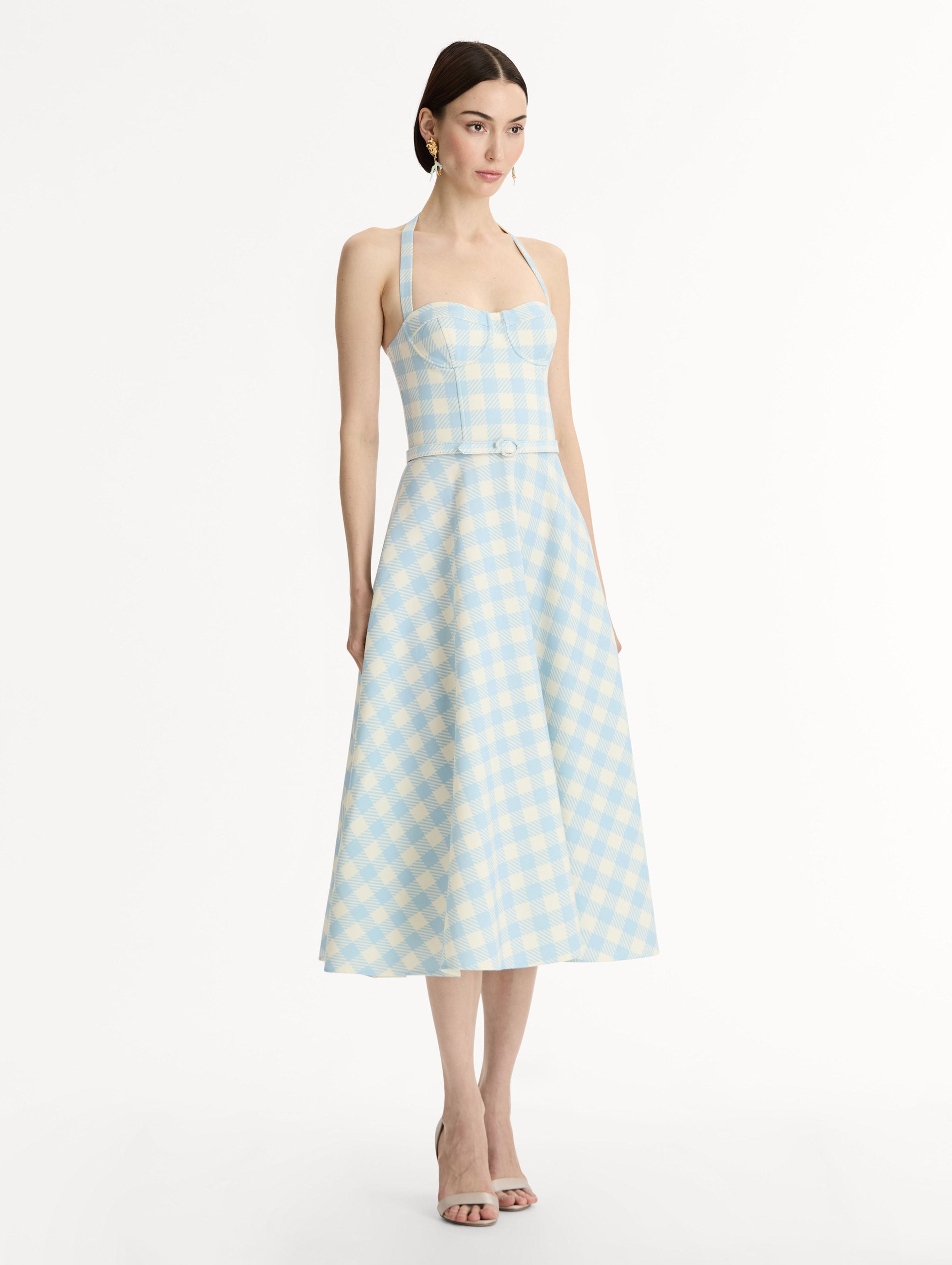 Pale blue and ivory gingham wool-blend halter dress. Structured bodice, flared midi skirt, and covered belt at the waist. Side View.