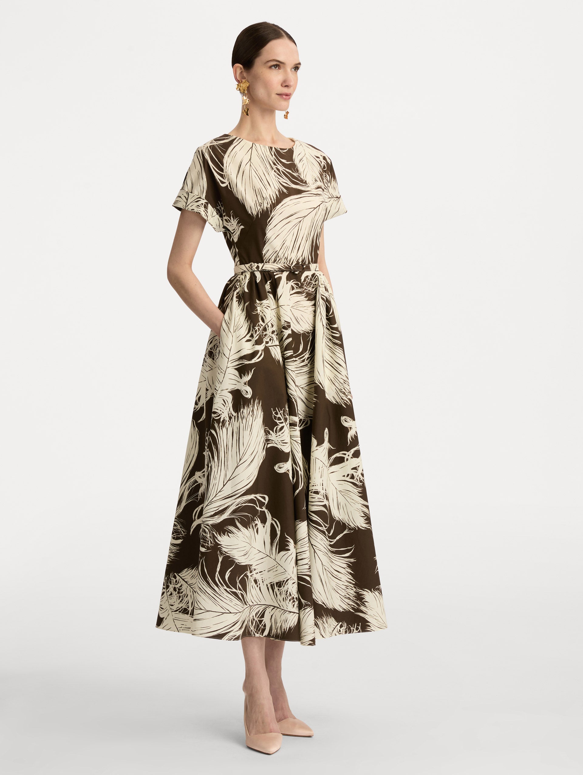 Ivory and Brown Feather Cotton Poplin Dress with short sleeves, fitted waist, and full skirt, featuring bold feather print throughout. Side View.