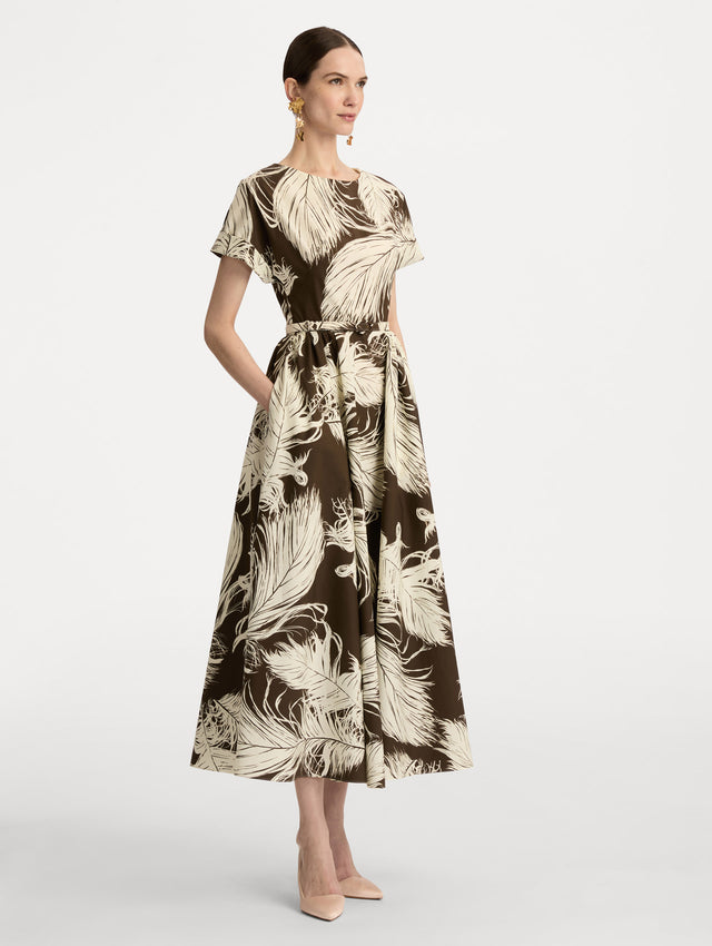 Ivory and Brown Feather Cotton Poplin Dress with short sleeves, fitted waist, and full skirt, featuring bold feather print throughout. Side View.