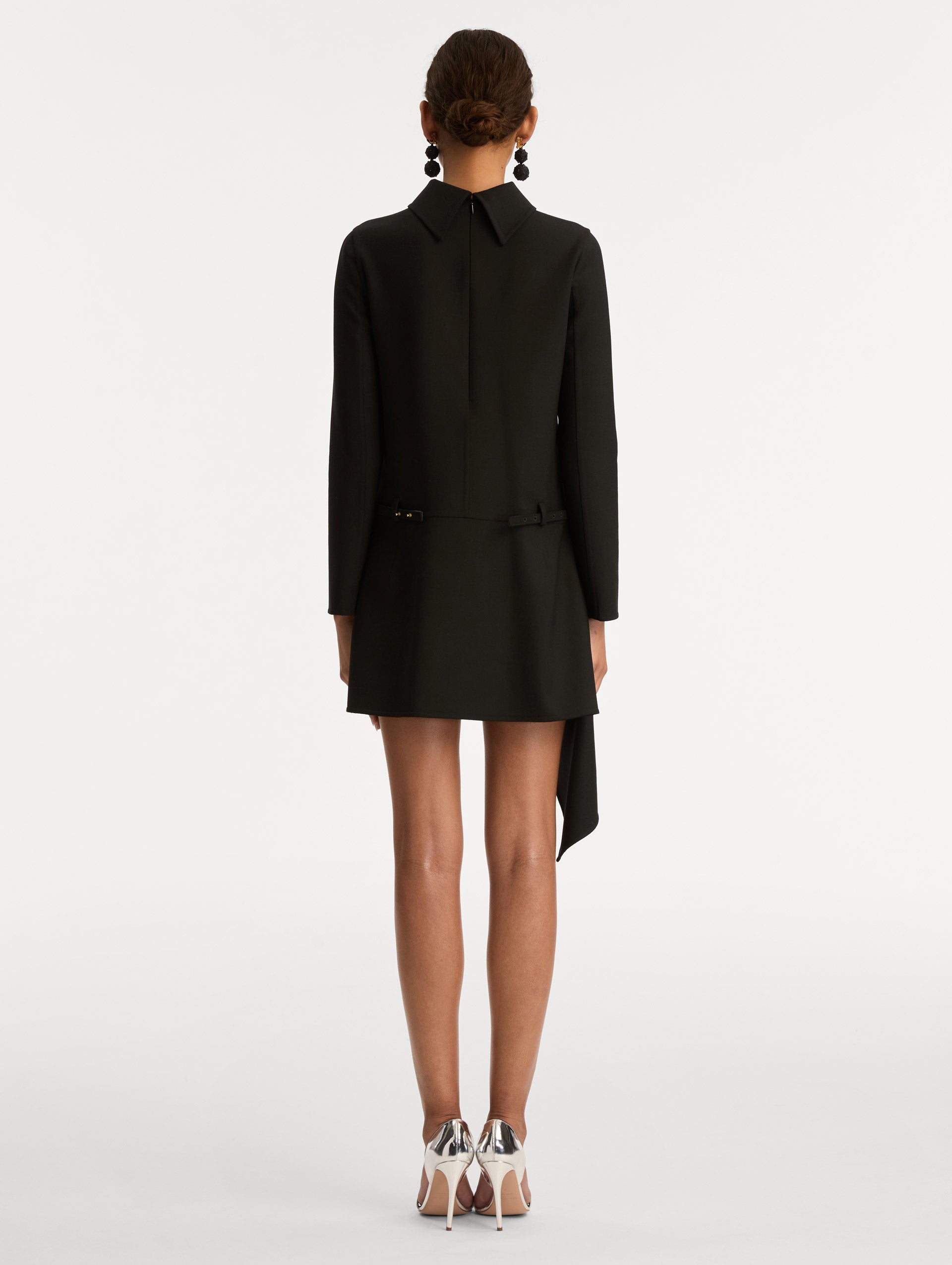 Black Floral Belt Mock-Neck Dress featuring a belt with a white flower and a black drape detail. Back View.