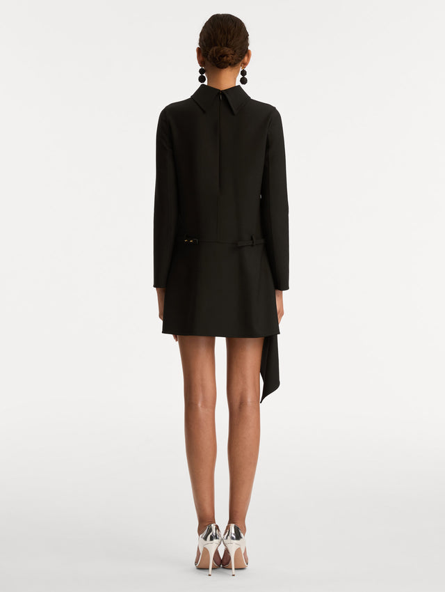 Black Floral Belt Mock-Neck Dress featuring a belt with a white flower and a black drape detail. Back View.