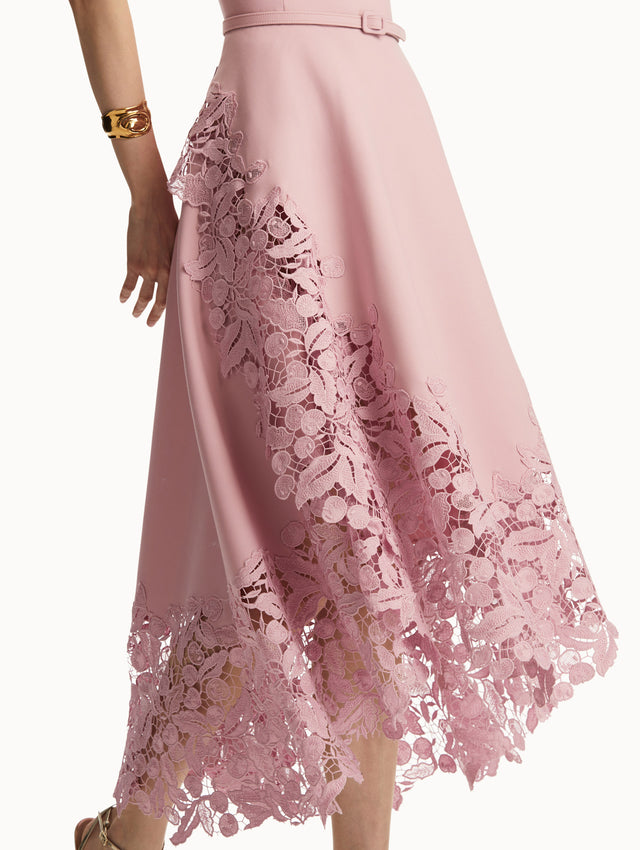 Sleeveless light pink dress with lace detail in the bottom and pink belt around the waist. Zoom view