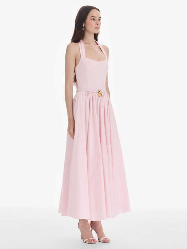 The model is wearing a sleeveless stretch cotton poplin sateen day dress. Back view.