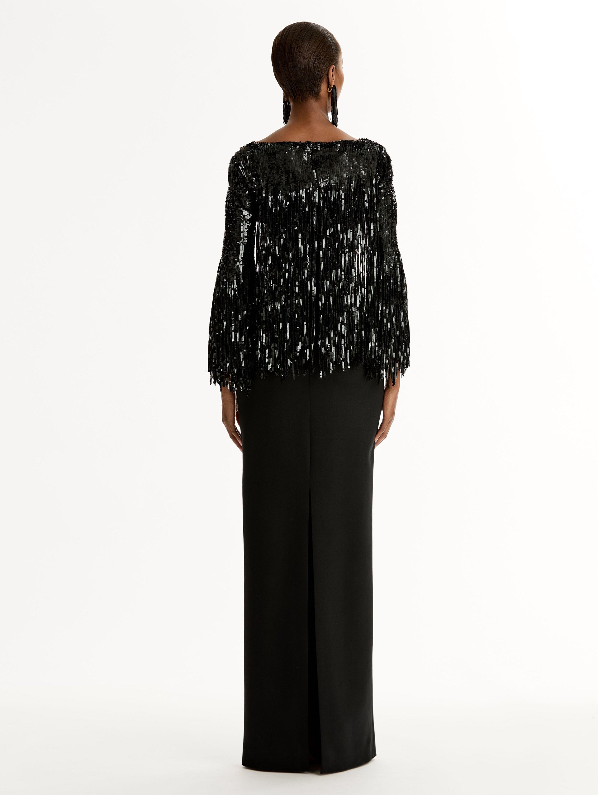 Black Sequin, Floor length gown in double-faced stretch wool. Open sleeves with beaded fringe. Back View.