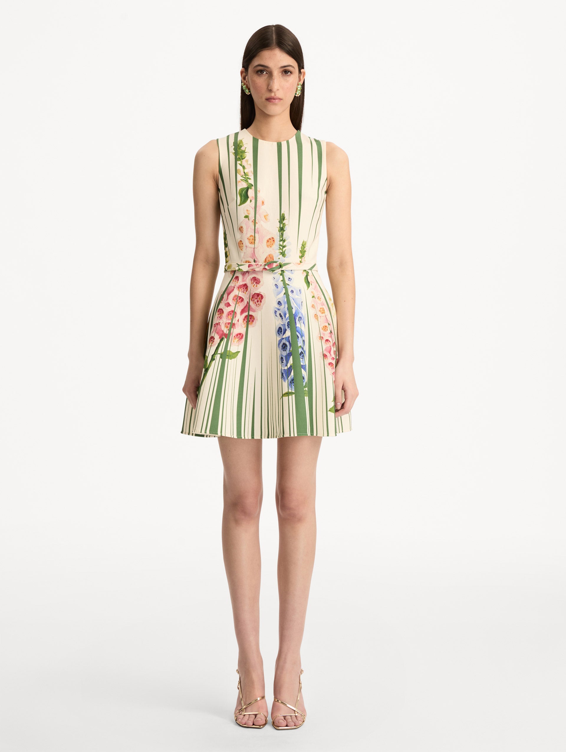Ivory and Green Foxglove Trompe L’oeil Dress with vertical green stripe accents and multicolor foxglove floral print, finished with a slim matching belt. Front View.