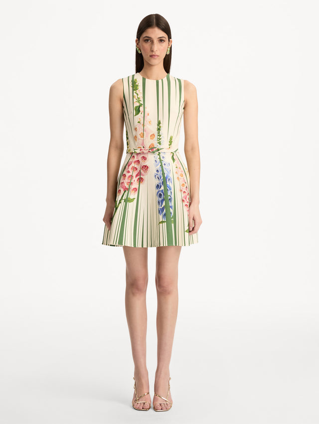 Ivory and Green Foxglove Trompe L’oeil Dress with vertical green stripe accents and multicolor foxglove floral print, finished with a slim matching belt. Front View.