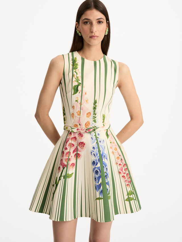 Ivory and Green Foxglove Trompe L’oeil Dress with vertical green stripe accents and multicolor foxglove floral print, finished with a slim matching belt. Front View.