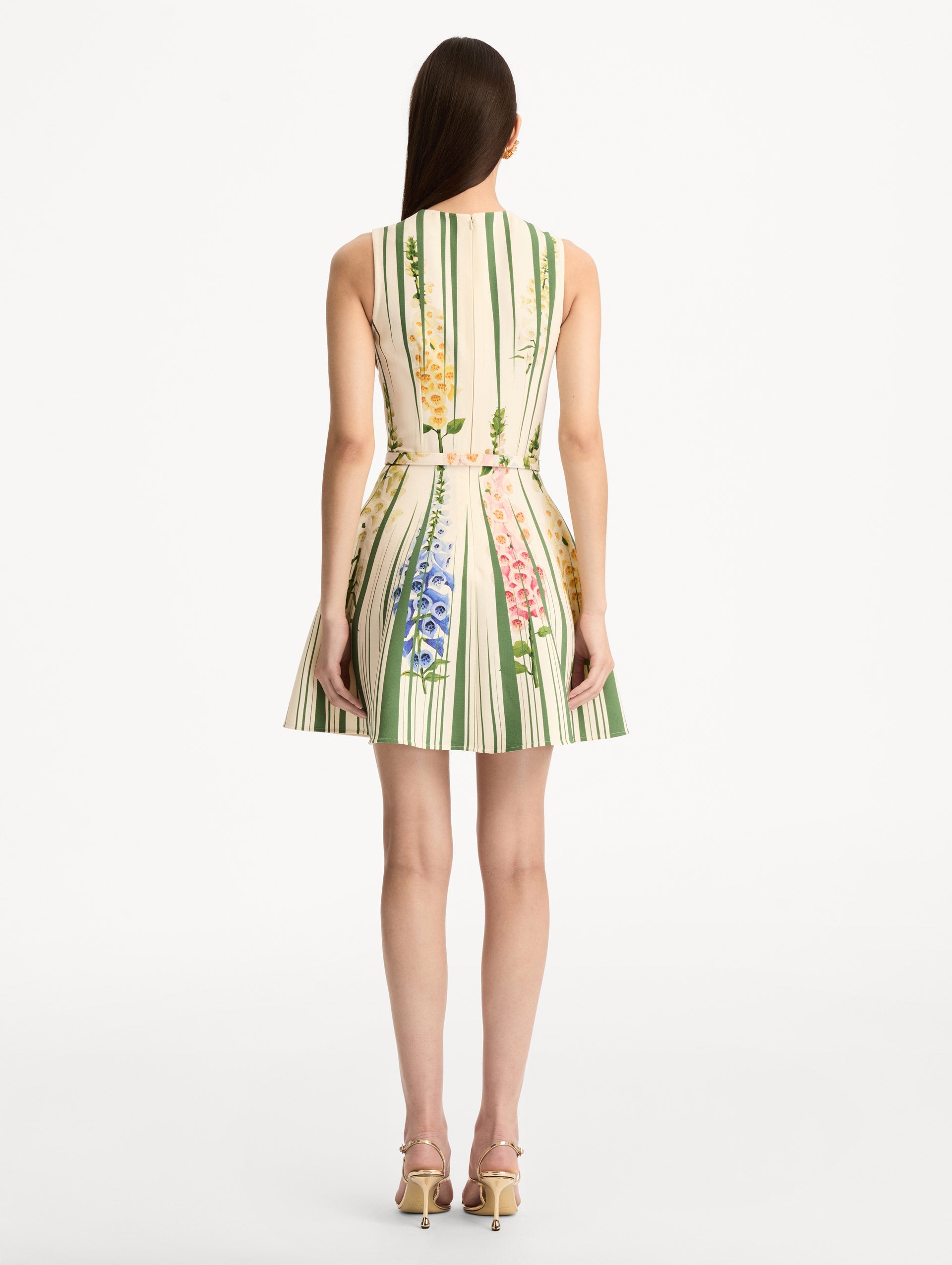 Ivory and Green Foxglove Trompe L’oeil Dress with vertical green stripe accents and multicolor foxglove floral print, finished with a slim matching belt. Back View.
