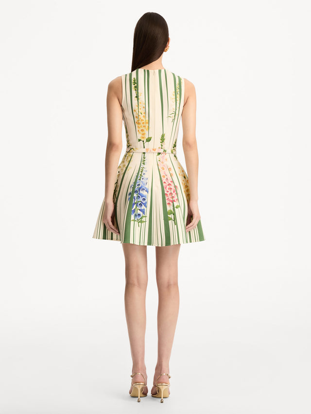 Ivory and Green Foxglove Trompe L’oeil Dress with vertical green stripe accents and multicolor foxglove floral print, finished with a slim matching belt. Back View.