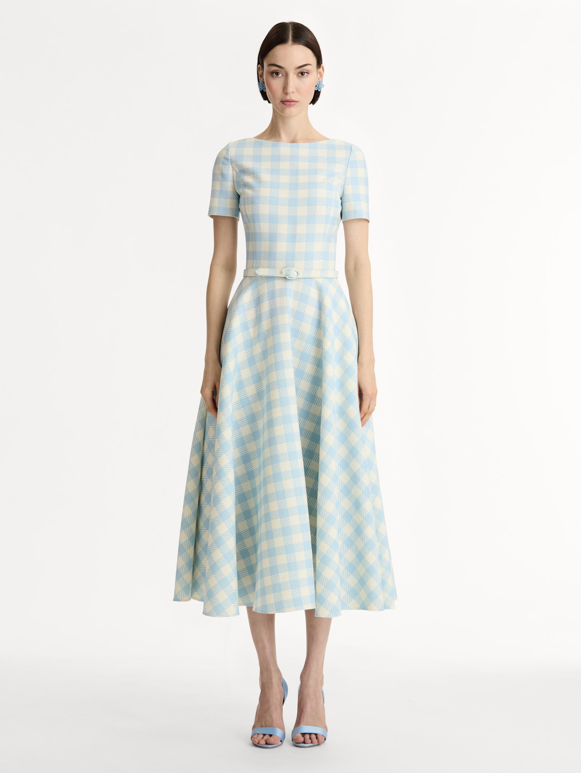 Pale blue and ivory gingham wool-blend midi dress. Fitted bodice, short sleeves, ull skirt, finished with a covered belt at the waist. Pocketed. Front View.