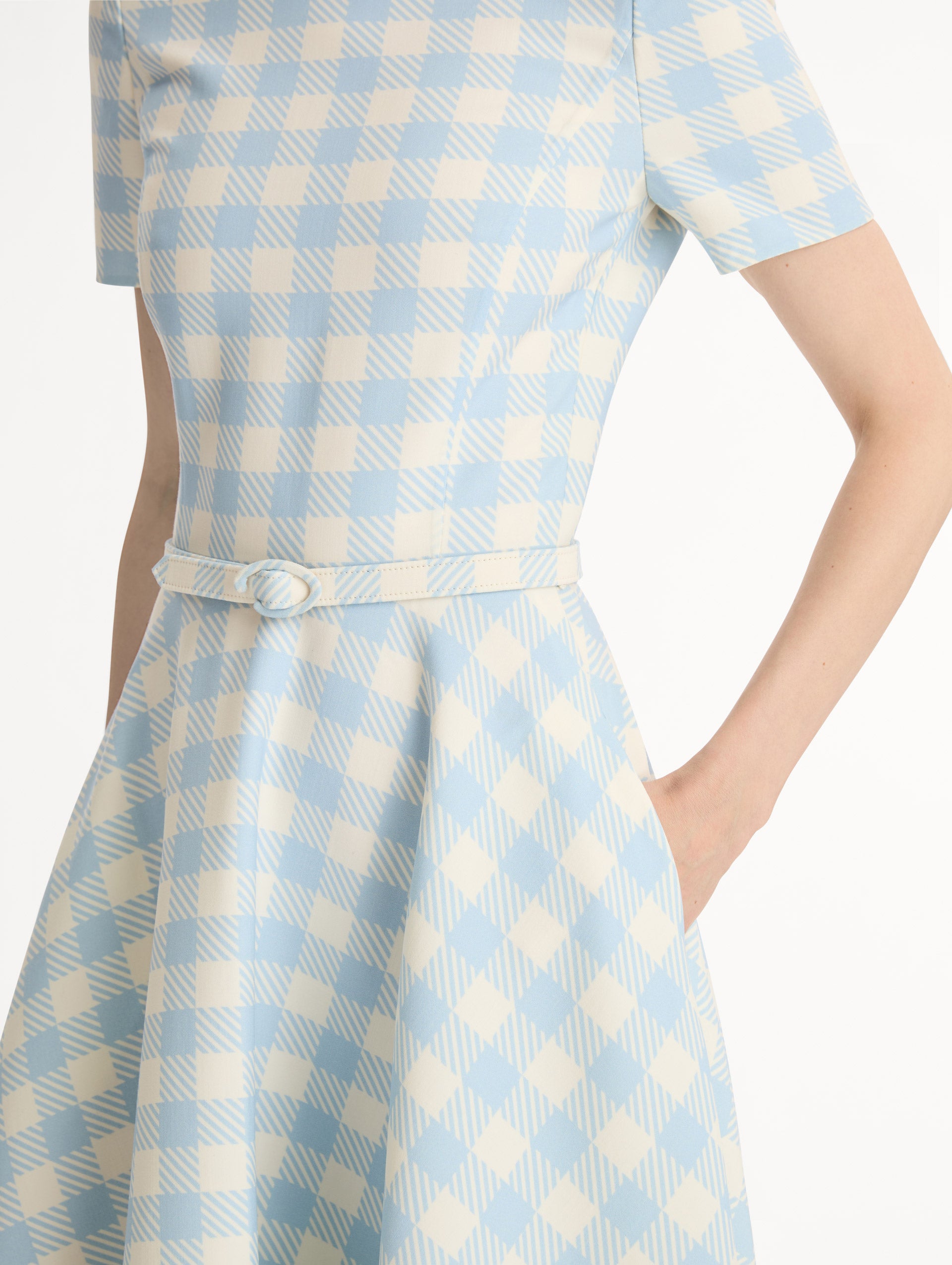 Pale blue and ivory gingham wool-blend midi dress. Fitted bodice, short sleeves, ull skirt, finished with a covered belt at the waist. Pocketed.. Side View. Close Up