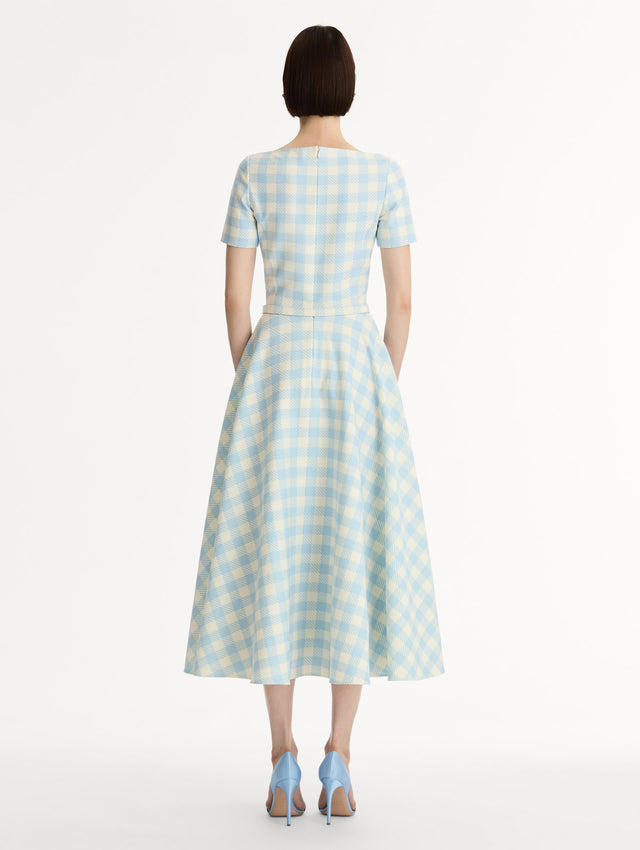 Pale blue and ivory gingham wool-blend midi dress. Fitted bodice, short sleeves, ull skirt, finished with a covered belt at the waist. Pocketed. Back View.