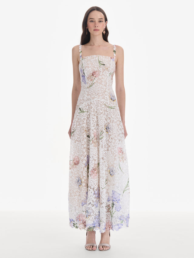 The model is wearing a sleeveless large iris degrade printed lace day dress. Front view.