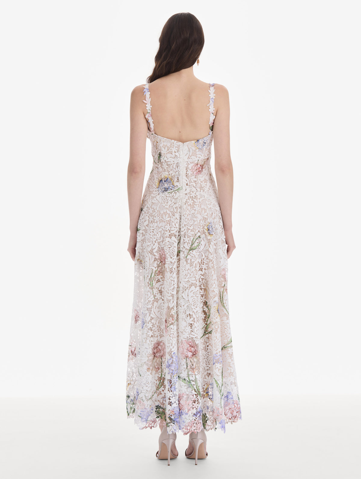 The model is wearing a sleeveless large iris degrade printed lace day dress. Back view.