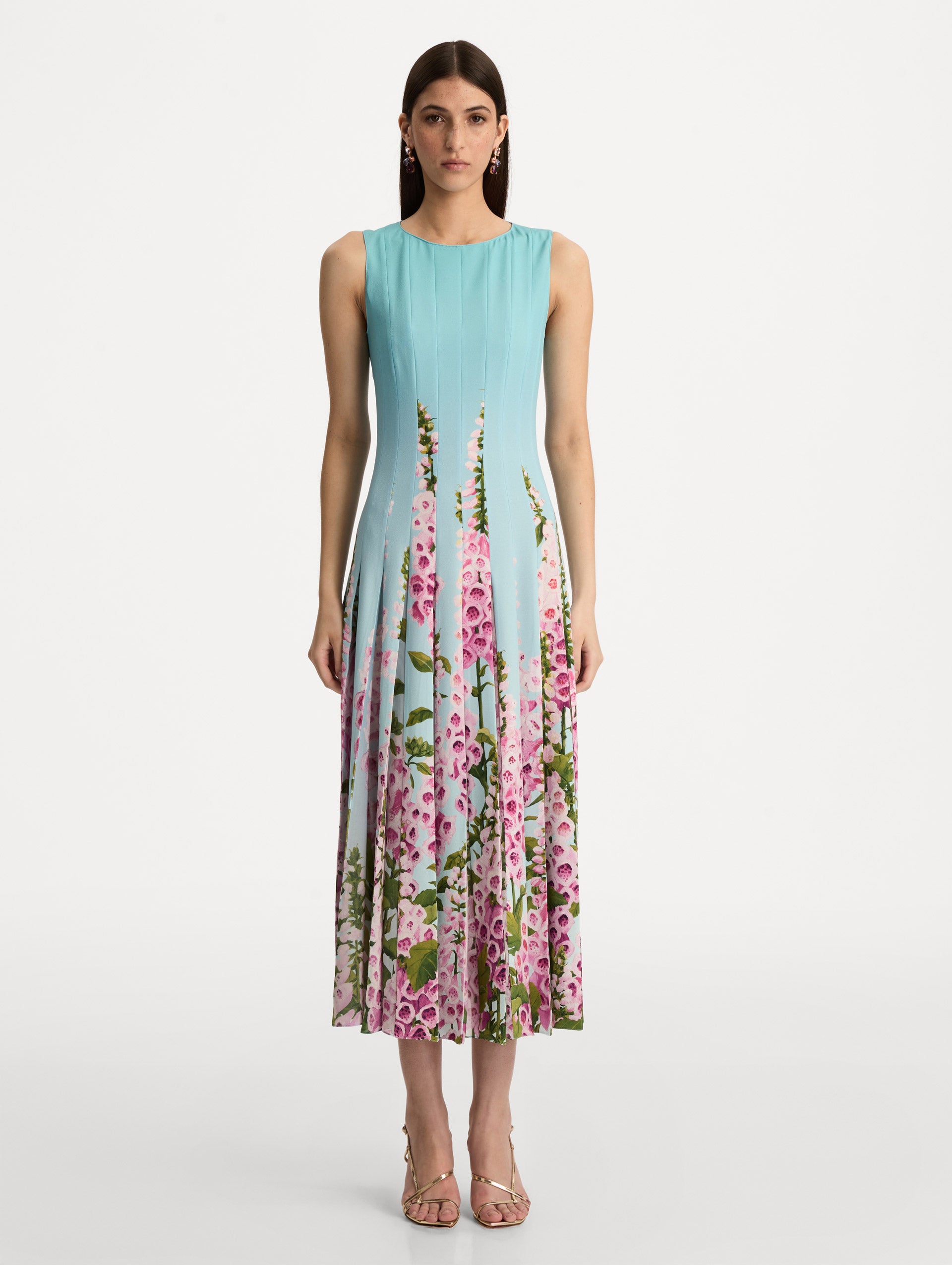 Blue Degradé Foxglove Chiffon Inset Dress featuring vertical pleats and a multicolor pink floral motif rising from the hem. Front View.