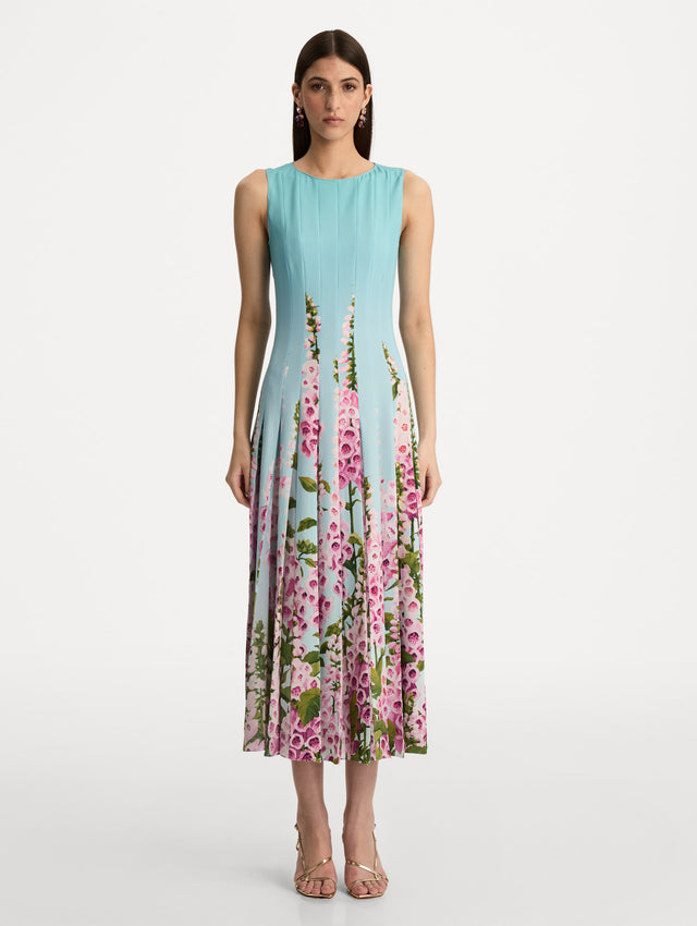 Blue Degradé Foxglove Chiffon Inset Dress featuring vertical pleats and a multicolor pink floral motif rising from the hem. Front View.