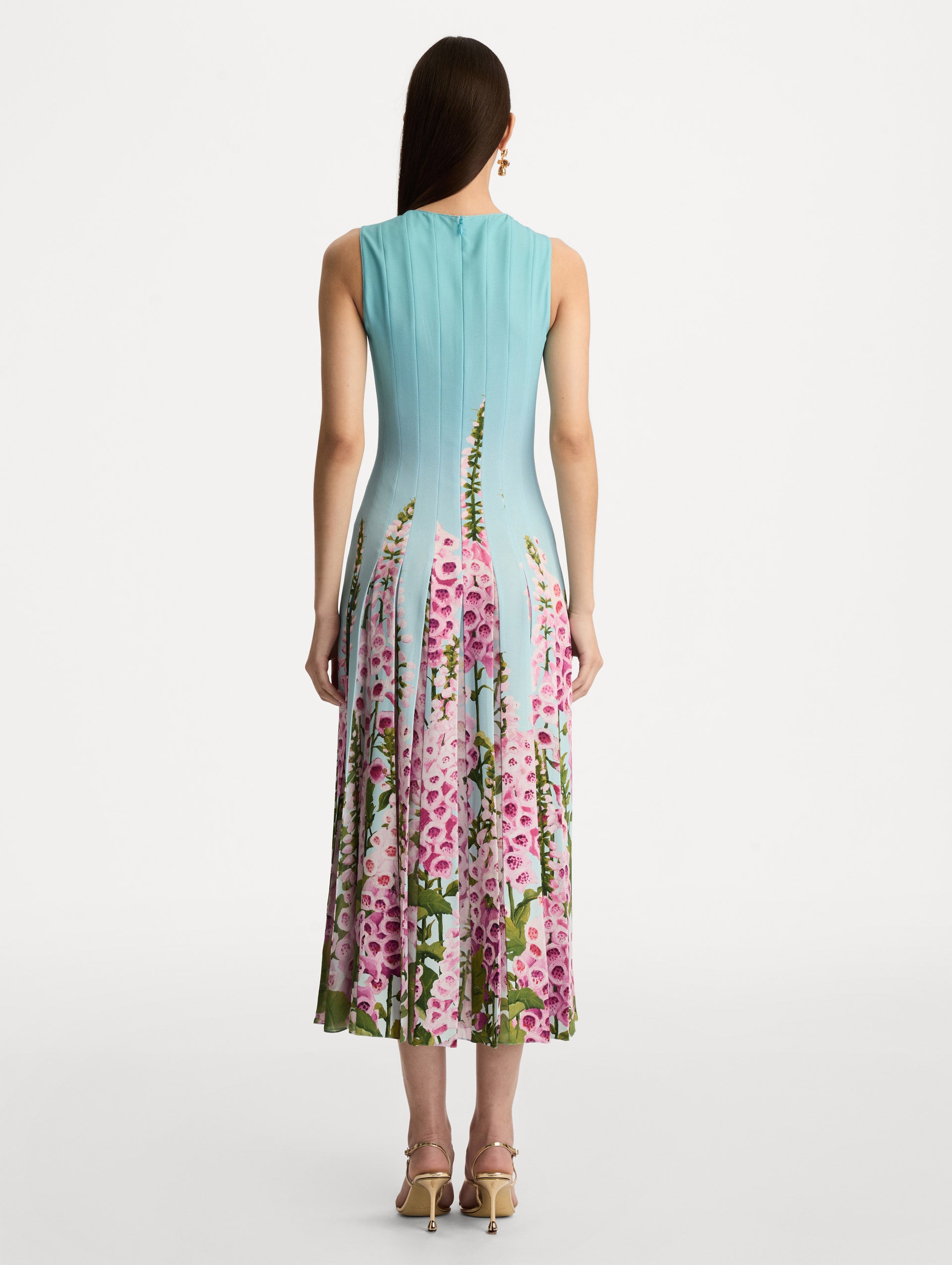 Blue Degradé Foxglove Chiffon Inset Dress featuring vertical pleats and a multicolor pink floral motif rising from the hem. Back View.