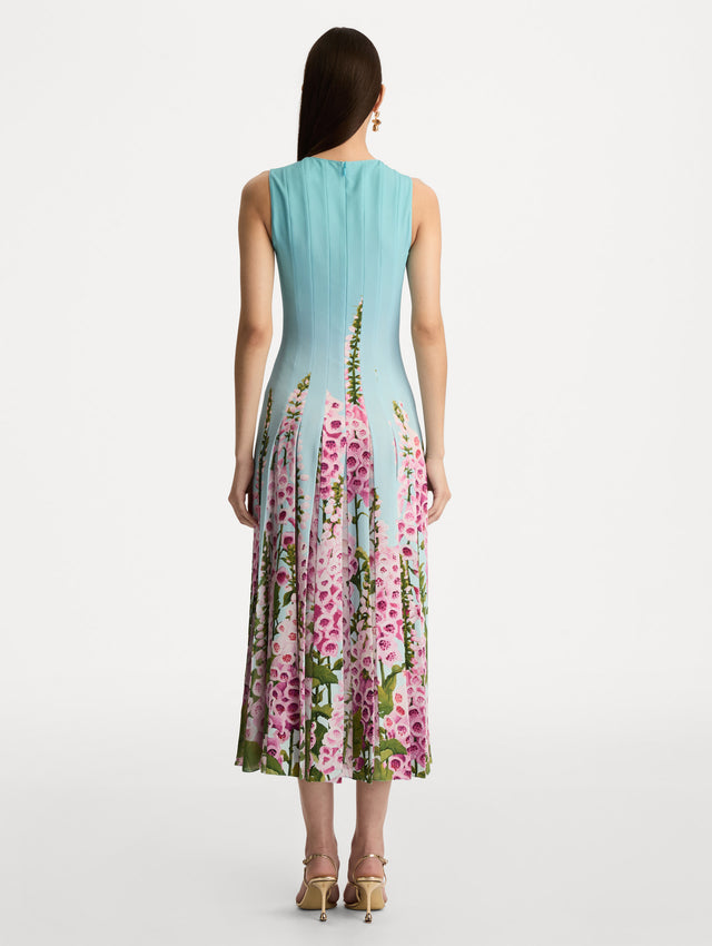 Blue Degradé Foxglove Chiffon Inset Dress featuring vertical pleats and a multicolor pink floral motif rising from the hem. Back View.