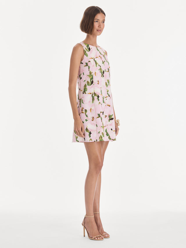 The model is wearing a sleeveless watercolor iris wool shift dress. Side view.