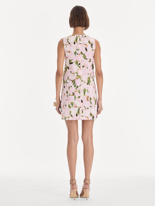 The model is wearing a sleeveless watercolor iris wool shift dress. Back view.