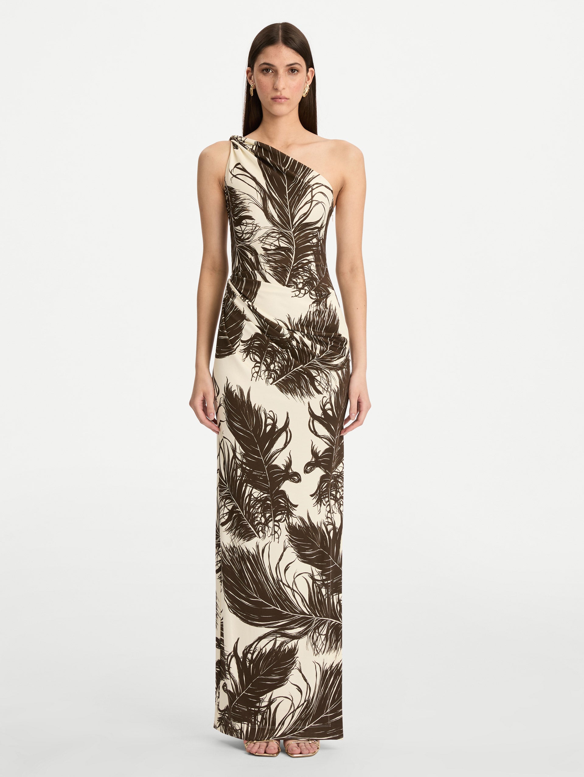 Ivory and Black Feather Jersey Maxi Dress with a one shoulder slim silhouette, featuring bold black feather print detailing. Front View.