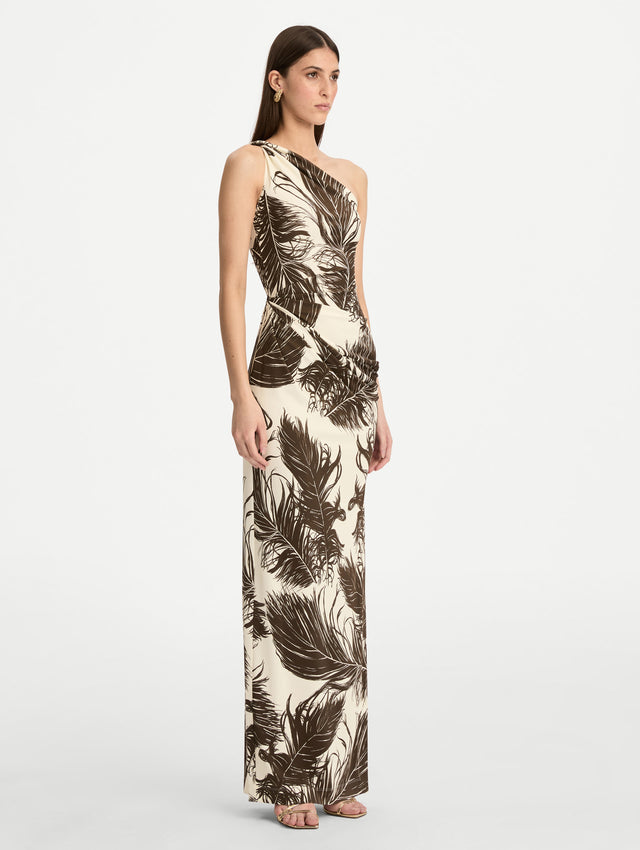 Ivory and Black Feather Jersey Maxi Dress with a one shoulder slim silhouette, featuring bold black feather print detailing. Side View.