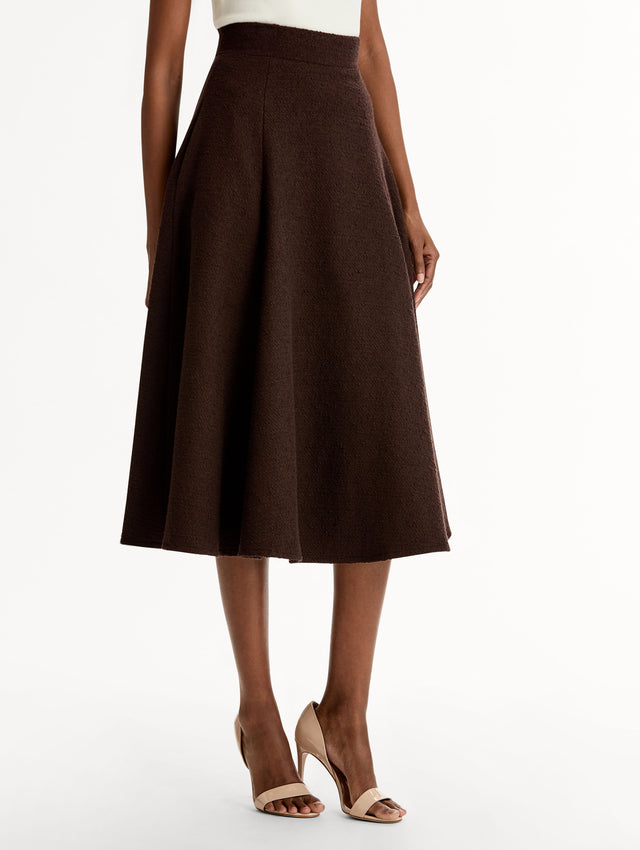 Chocolate Wool Tweed Pleated Skirt with pockets, High-waisted with Flared Fit. Side View.