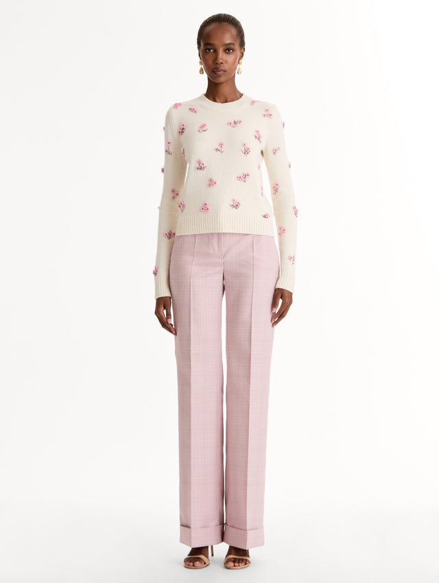 Crew neck, long sleeve sweater with pink floral embellishments. Front View.