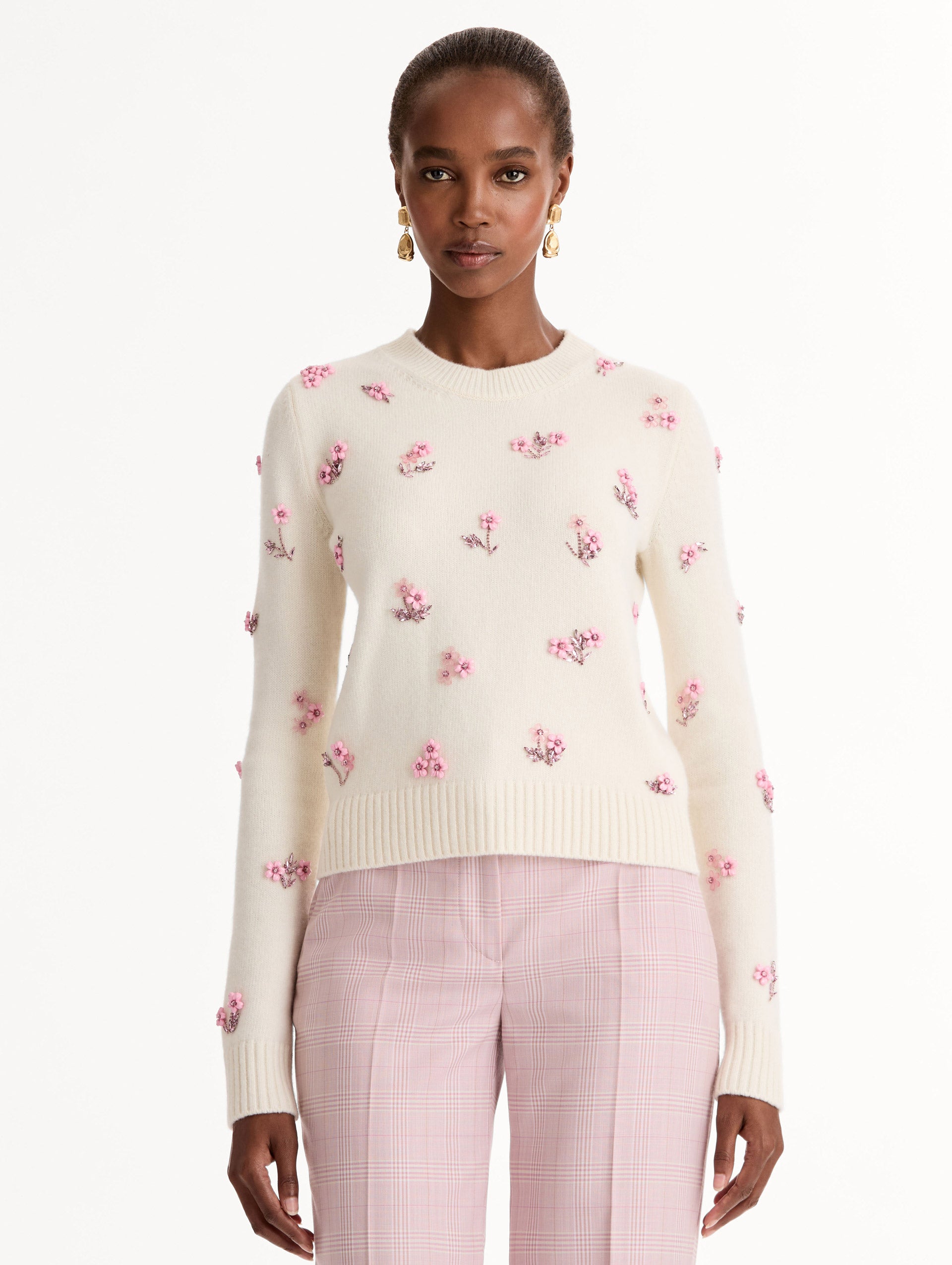 Crew neck, long sleeve sweater with pink floral embellishments. Front View.
