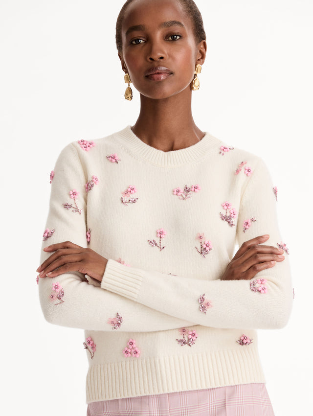 Crew neck, long sleeve sweater with pink floral embellishments. Front View Close Up.