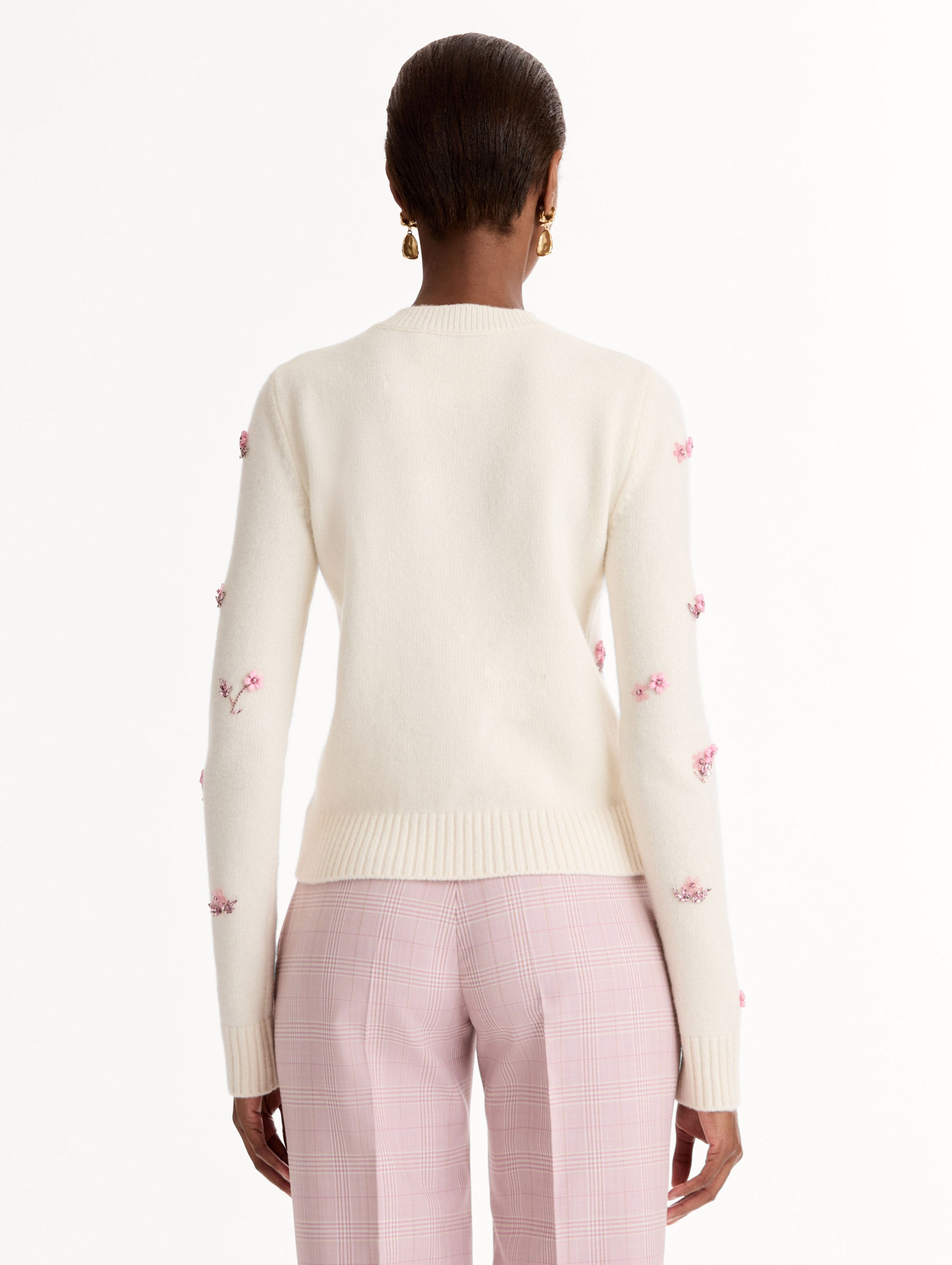 Crew neck, long sleeve sweater with pink floral embellishments. Back View.