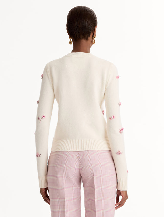 Crew neck, long sleeve sweater with pink floral embellishments. Back View.