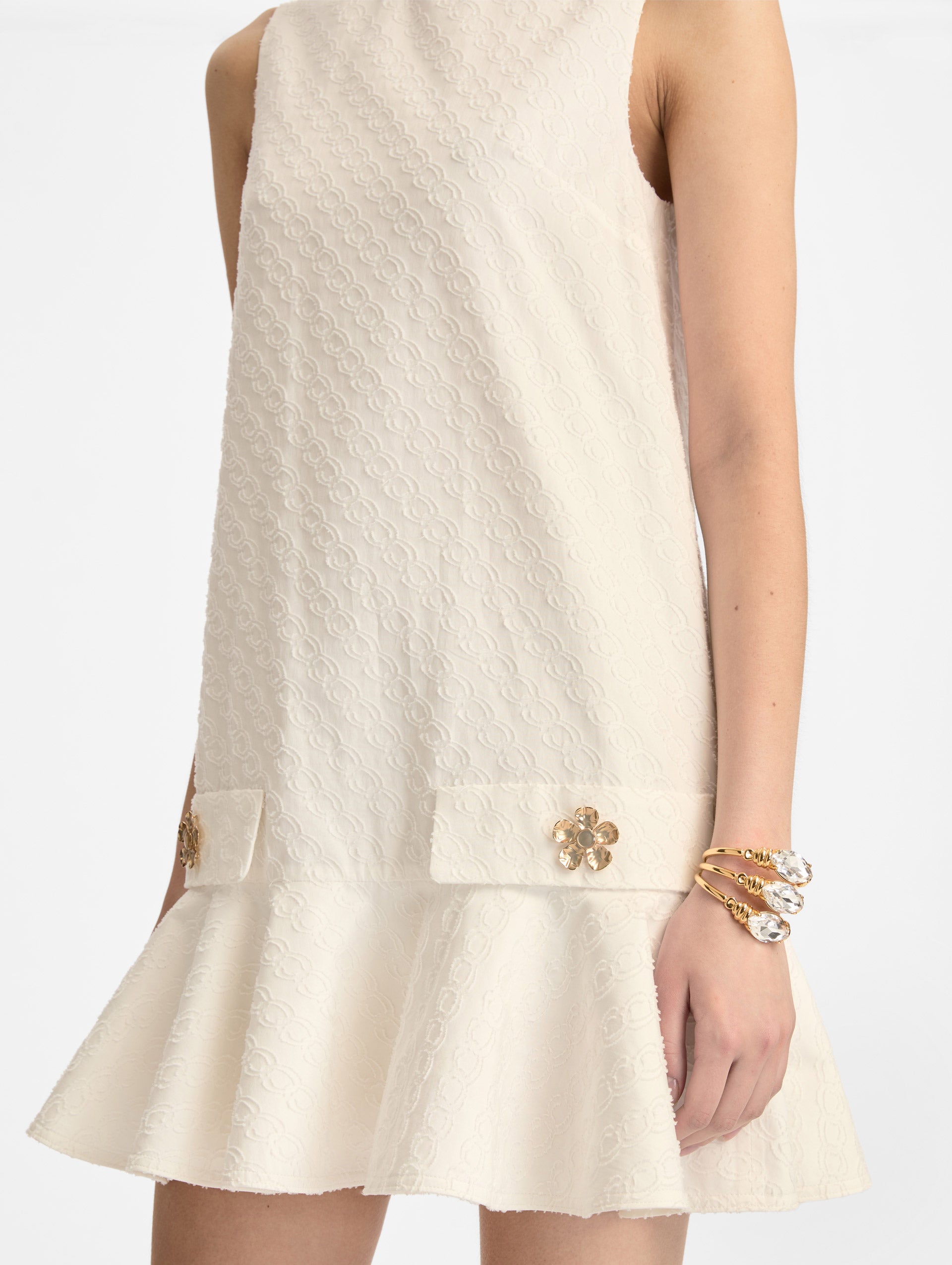 White Oscar Chain-Link Cotton Poplin Dress with drop waist, flared hem, and gold floral button accents on front pockets. Zoom View.